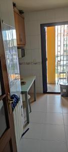 a kitchen with a table and a door to a room at Ciudad De Sada in Sada