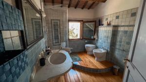 a bathroom with a sink and a toilet at Villa Pleiadi in Casa Albonetti +20 photos