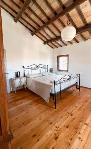 a bedroom with a bed and a wooden floor at Villa Pleiadi in Casa Albonetti