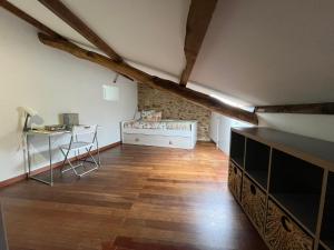 an attic room with a desk and a table at La casa del valle in Viveiro
