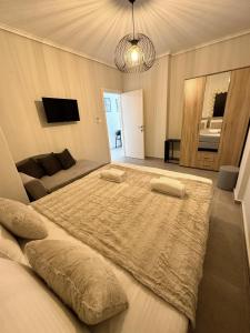 a bedroom with a large bed with two pillows on it at SUNRISE SEA VIEW SUITE by Eden in Paralia Katerinis +36 photos
