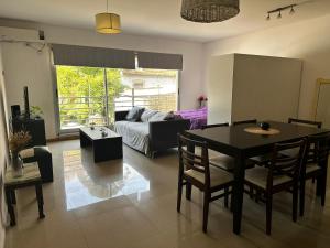 a living room with a table and a couch at Lovely & Lightful Studio with pool in San Fernando