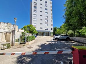 a car parked in a parking lot in front of a building at Apartman Diana in Zadar