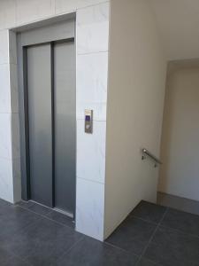 a room with two glass doors and a wall at Anuya B1 in Flic-en-Flac