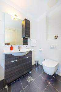 a bathroom with a sink and a toilet at Apartman Diana in Zadar +26 photos