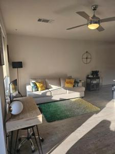 a living room with a white couch and a table at Beautiful Condo on Riverwalk w King Ste free parking pet friendly Centrally Located in San Antonio +28 photos