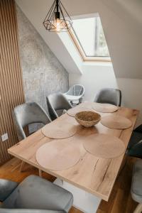 a dining room with a wooden table and chairs at Pine Lux Zlatibor in Zlatibor