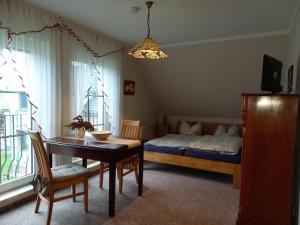 a bedroom with a bed and a table and a dining room at Ferienwohnung Hofapartment in Milkersdorf