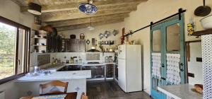 a kitchen with a white refrigerator and a sink at B&B Della Via Francigena in Agrigento