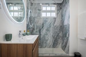 a bathroom with a sink and a shower at Villa Pedreiro in Funchal +56 photos