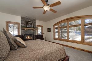 a bedroom with a bed and a fireplace at Dreamcatcher at Lakota home in Winter Park