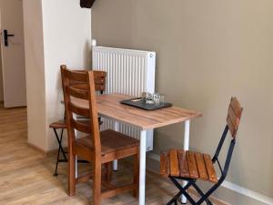 a wooden table with two chairs and a table with a tray at Apolla 34 in Poznań