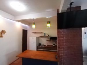 a kitchen with a white refrigerator and a counter top at Casa IAIA in Mexico City
