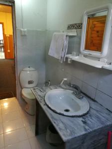 a bathroom with a sink and a toilet at Last Resort, Sajjan Gali in Nathia Gali