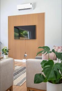 a living room with a tv on a wall at Stunning House in Constantia in Cape Town