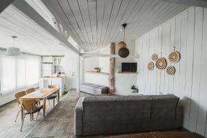 a bedroom with a bed and a table and a dining room at The Garden House in Kavála