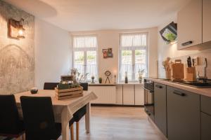 a kitchen with a table and a dining room at Ferienhaus Castle View Quedlinburg in Quedlinburg