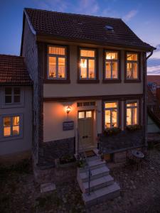 a house with its lights on in the evening at Ferienhaus Castle View Quedlinburg in Quedlinburg