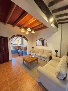 a living room with two couches and a table at Apartamentos turísticos "El Refugio" in Algar de Palancia +26 photos