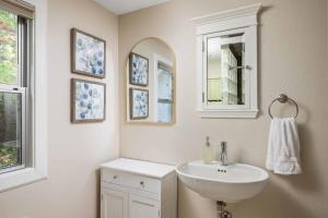 a white bathroom with a sink and a mirror at Riverwood Retreat in West Linn +40 photos