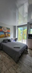 a bedroom with a large bed and a large window at Las Aguas Inner Experience in Bogotá
