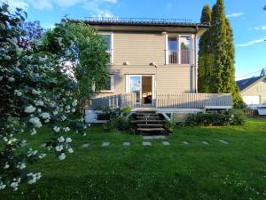 a house with a porch and a yard at Villa with the garden in Hokksund