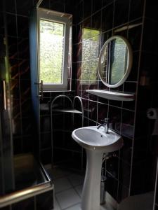 a bathroom with a sink and a mirror at Dom Letniskowy nad jeziorem in Wilkasy +23 photos