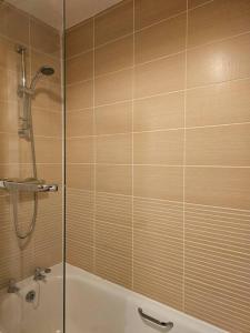a bathroom with a shower and a bathtub with a shower at The Park view, 2 Bedroom House in Kirkcaldy