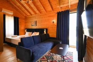 a living room with a couch and a bed at Bujtina Kapinova in Berat +64 photos