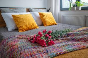 a bunch of red flowers sitting on a bed at Studio Olesińska in Warsaw +19 photos