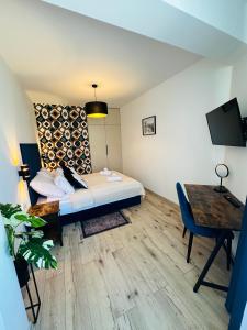 a room with a bed and a table and a desk at Nadmorski czas Darłówko in Darłowo