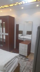 1 dormitorio con 2 camas, tocador y espejo en استديوهات Hs 3, en El Cairo