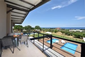 a balcony with a view of the ocean at Olive All-Seasons Suites, Panel Hospitality Homes & Villas in Litochoro