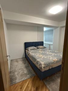 a bedroom with a bed in a small room at Belma's Apartment in Sarajevo