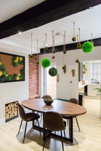 a dining room with a table and chairs at The Jungle! House with Hot Tub. in Nottingham