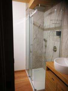 a bathroom with a glass shower and a sink at casa del corso 27 in Sirolo +8 photos