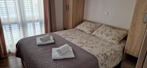 a bedroom with a bed with two towels on it at Villa Toni II in Biograd na Moru