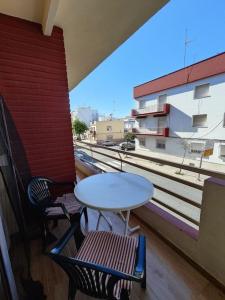 a table and two chairs on a balcony at Apartamento en Isla Cristina in Isla Cristina