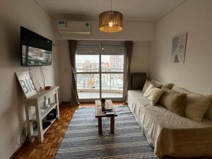 a living room with a couch and a table at Tigre Center Tower i - Con piscina y seguridad 24hs - Opcional cochera in Tigre