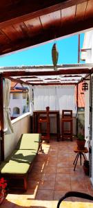 a patio with a table and chairs and an umbrella at Nikolina Rab Apartments in Rab