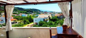 a balcony with a view of a city at Nikolina Rab Apartments in Rab