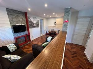 a living room with a couch and a tv at Casita independiente Casa Corban in Santander