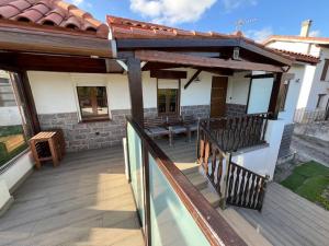 an outdoor deck with awning on a house at Casita independiente Casa Corban in Santander