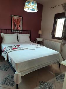 a bedroom with a large bed in a room at House with View in Agia Paraskevi