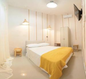 Postel nebo postele na pokoji v ubytování Hostal Mamà Mambò - Zona Colonial