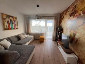 a living room with a couch and a tv at Wohnung mit schönem Aussicht in Bendorf