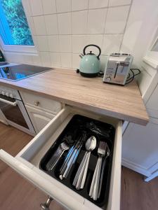 a kitchen counter with a tea kettle and utensils at Wohnung mit schönem Aussicht in Bendorf +19 photos