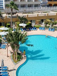 a person standing in a pool at a resort at Porto marina special chalet sea view in El Alamein