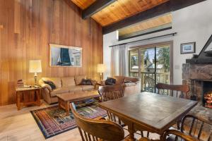 a living room with a table and a fireplace at Corwin's Quarters in Kings Beach