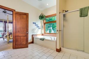 a bathroom with a tub and a shower stall at Great Lake Erie Getaway with Hot Tub and Private Beach in Avalon Beach +28 photos